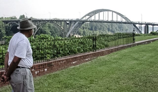 Scott B. Smith, Jr. looks out at the Edmund Pettus Bridge in Selma, AL. (Photo by Ben Greenberg.)